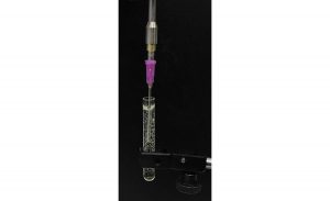 Figure 3. A device currently in testing is based on a viscosity sensor with a Luer taper on its tip to enable the connection of a conventional disposable dosing needle to extend its sensitive element.